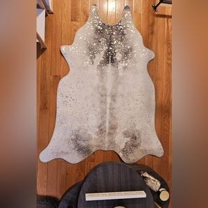 Faux cowhide rug with metallic accents.